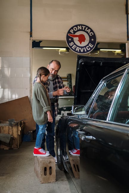 Father and daughter bonding in a garage, learning car repair together.