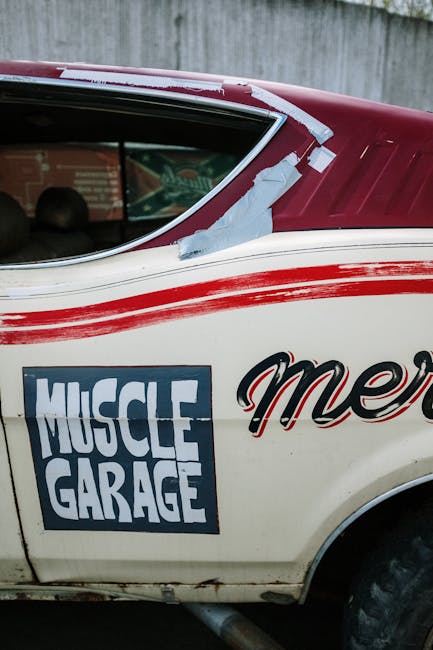 Close-up of a retro muscle car with 'Muscle Garage' signage on the door.