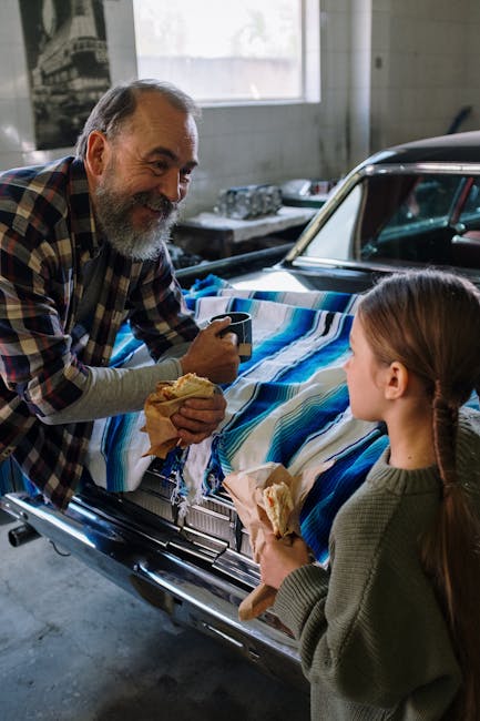 A heartfelt moment as father and daughter enjoy a snack break in an auto repair shop.